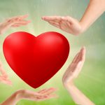 adult and child hands holding red heart, health care, love and family insurance concept, world heart day,