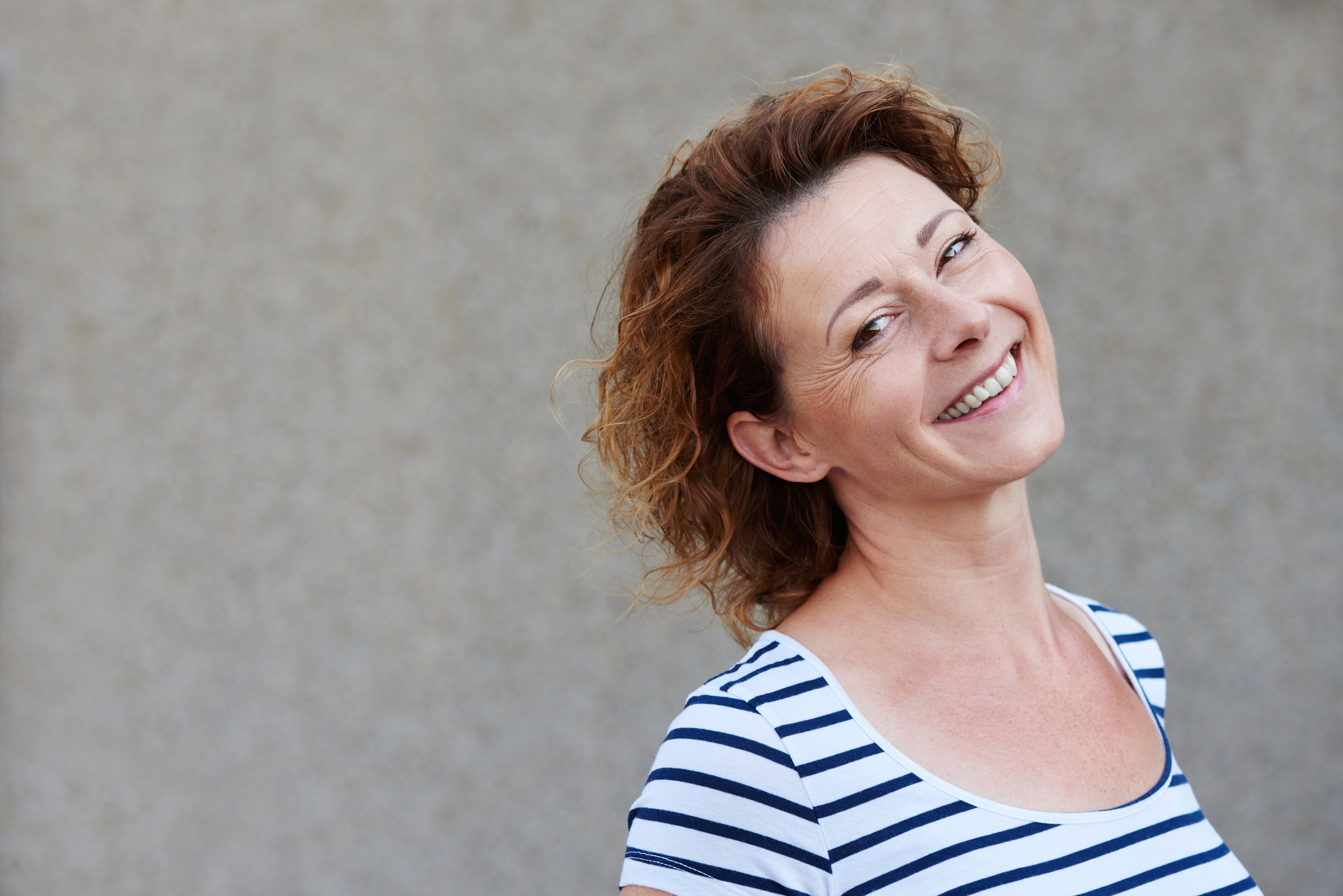 smiling woman wearing striped shirt