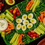 Platter of various vegetables, dips and deviled eggs