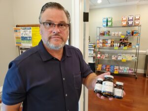 Dr. Simonds holding Metagenics VItamins