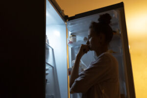 Woman looking in fridge