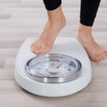 Person Stepping On Weighing Scale
